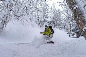 A snowboarder explores the backcountry outside of Bolton Valley ski area in Vermont.