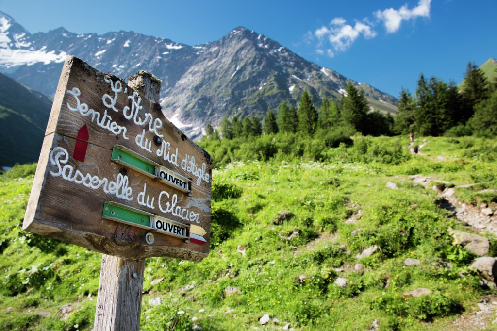 A trail marker offers alternative route directions on the Tour du Mont Blanc.