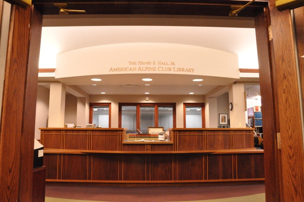 A long wooden counter greets visitors to the American Alpine Club Library in Golden, Colo.