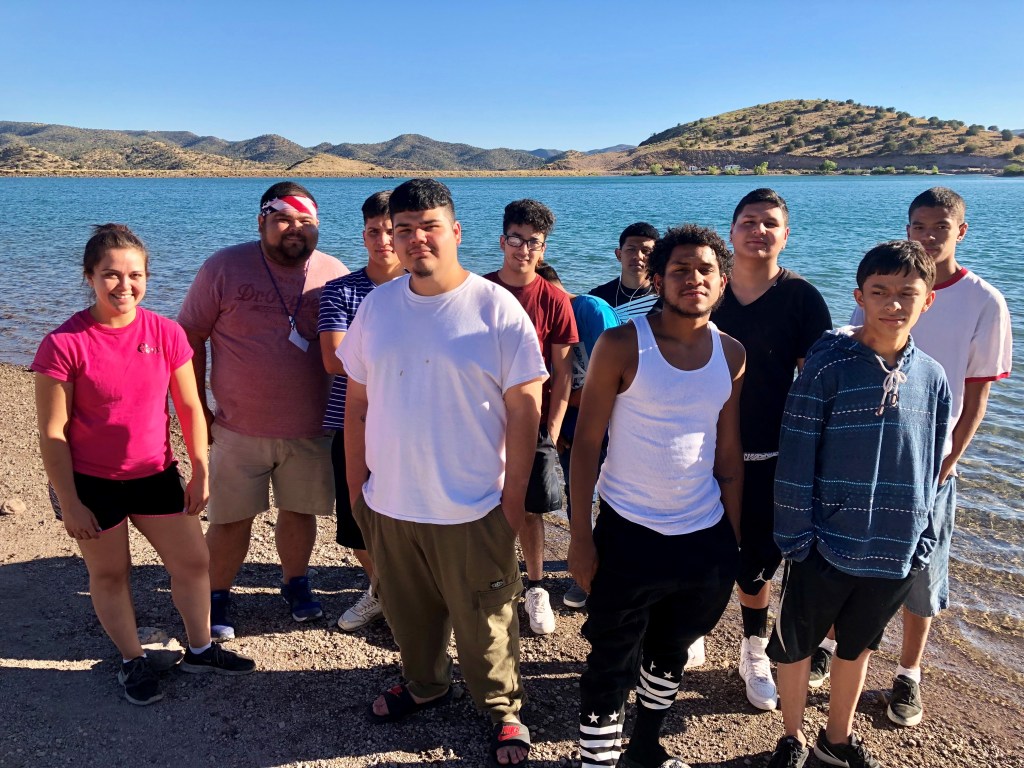 Teenagers stand near a body of water in the Gila Wilderness