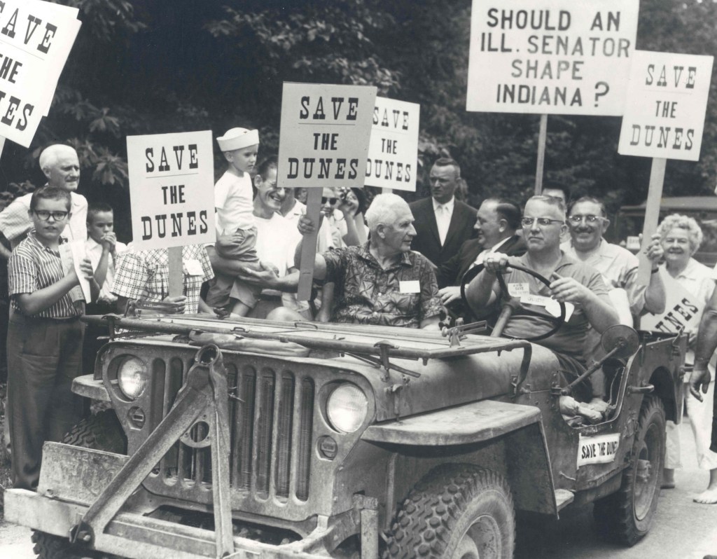 People holding "Save the Dunes" signs