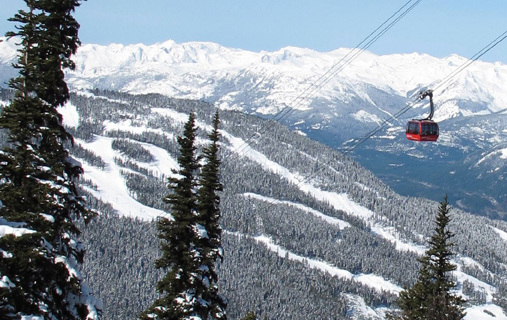 The Peak2Peak Gondola rises high above ski trails in the distance.