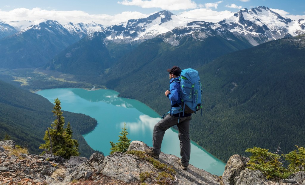 An REI Adventures backpacker enjoys a grand vista deep in the British Columbia wilderness.