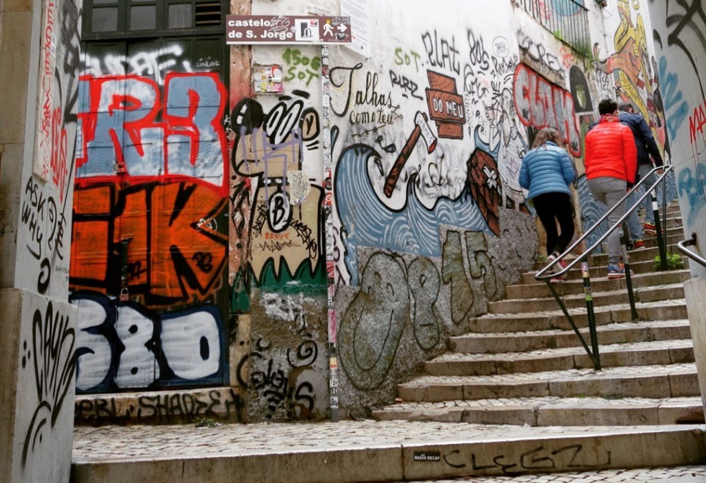 The author wanders the graffiti-covered alleyways of Lisbon, Portugal.