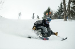 Trevor Kennison uses a sit ski and outriggers to ski down the slope.