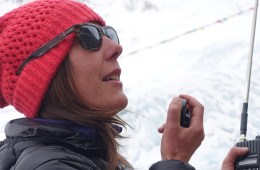 Dr. Monica Piris uses a radio to communicate at a high-altitude base camp.