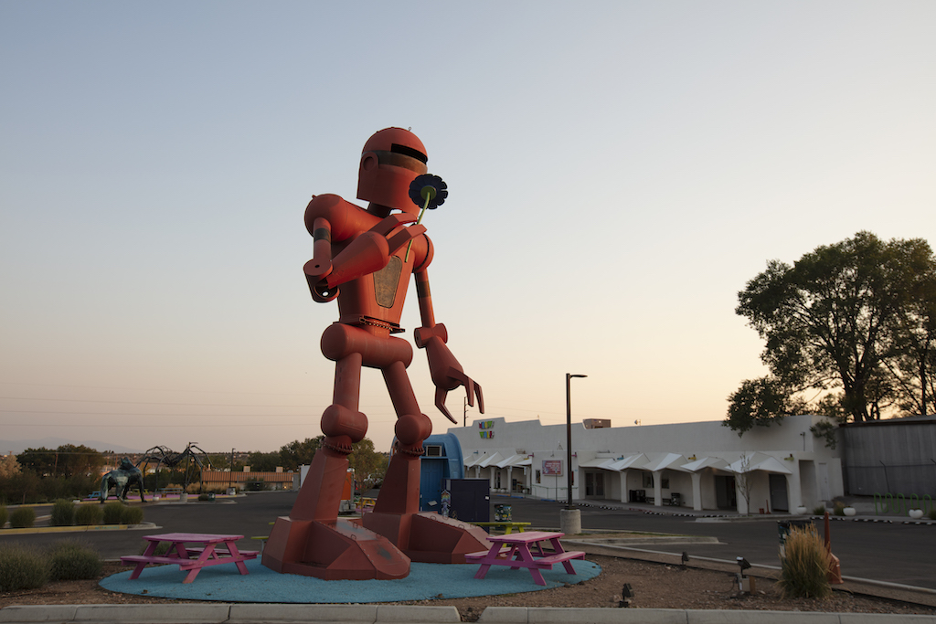 A large robot statue stands outside of The exterior of Meow Wolf's House of Eternal Return in Santa Fe, New Mexico.