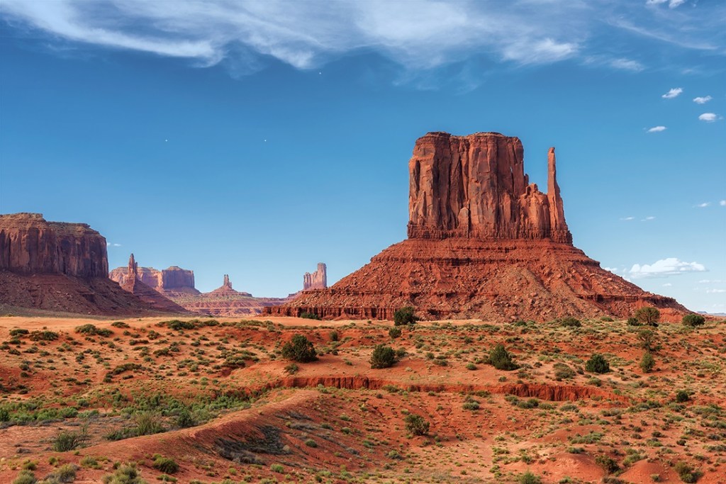 Sandstone buttes rear into the sky in Monument Valley.