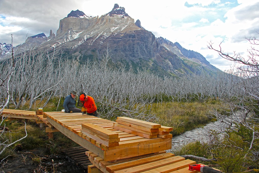 Volunteers work on a section of boardwalk in Torres del Paine. 