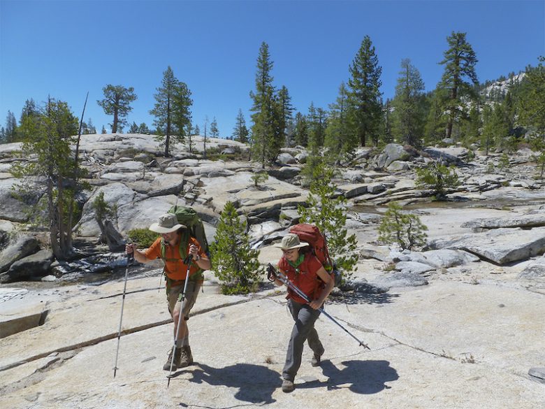 Hikers walk over the granitic bedrock of Sequoia National PArk.