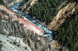 River shown far below the grey rocks.