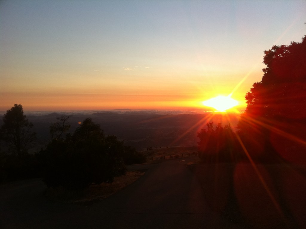 A orange sunset behind a dark foreground.