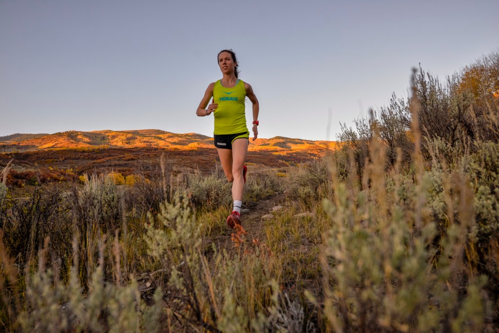 Anna Mae Flynn, who's 32, runs down a trail.