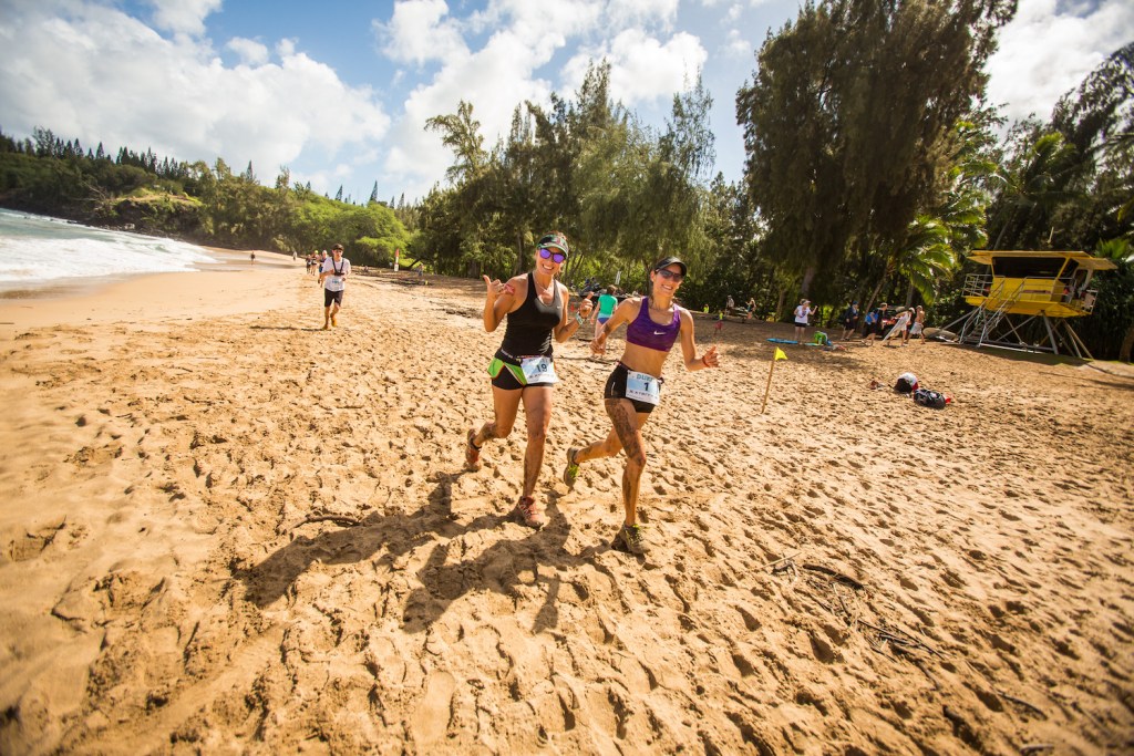 Runners jog along the beach in the Kapalua 10K in Hawaii.