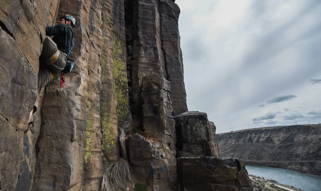 A climber works his way up the basalt rock that forms the Black Cliffs. 