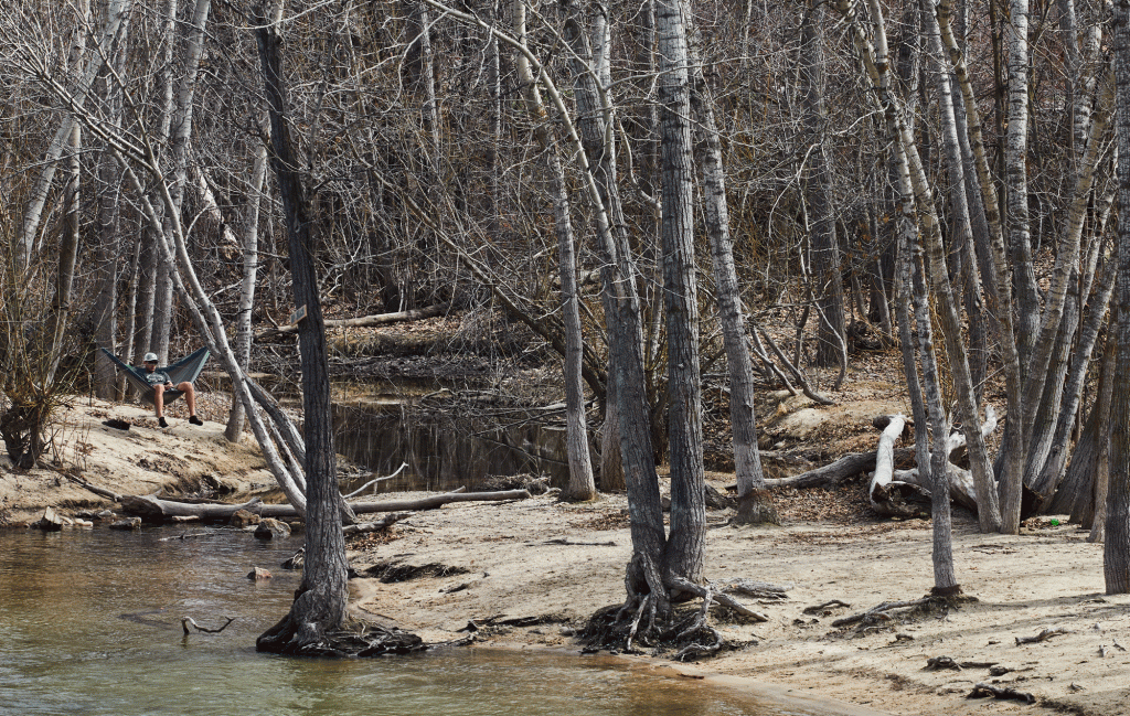 A Boisean lounges in a hammock next to the Boise River. 