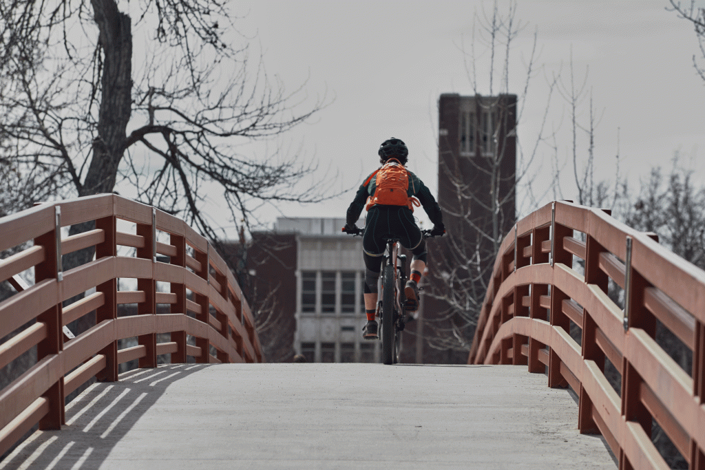 A cyclist crosses a bridge on the Boise River Greenbelt.