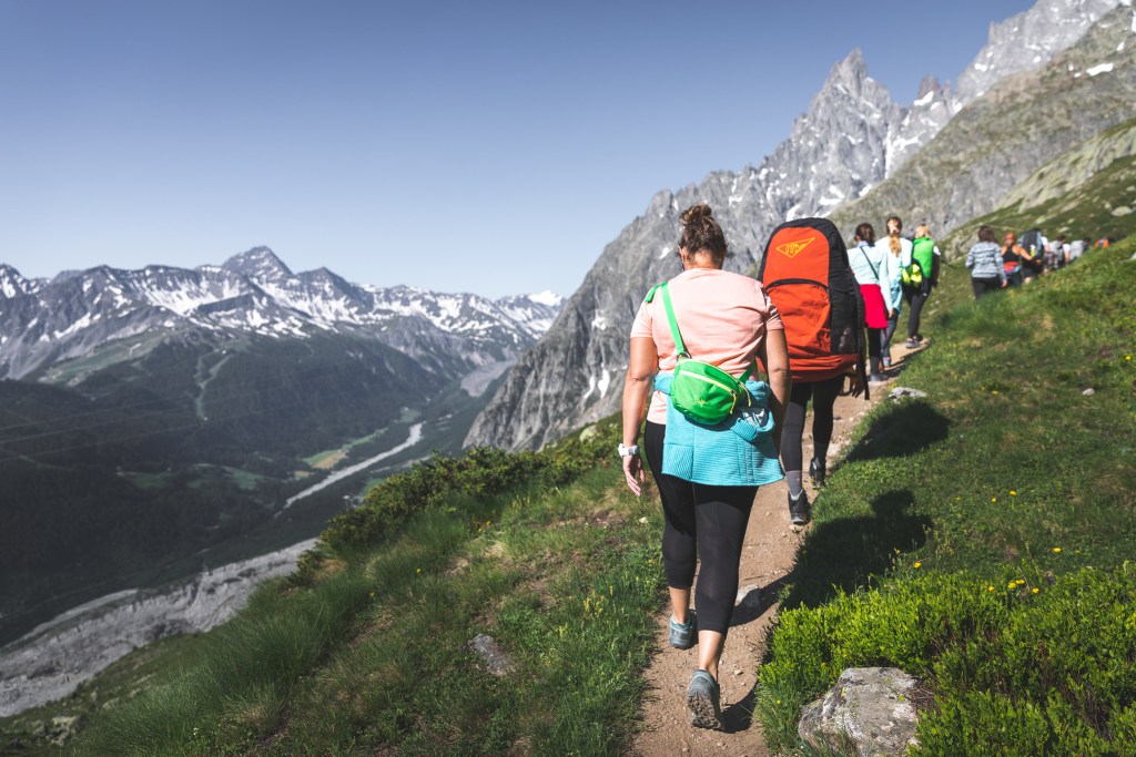 A group of women hike up a dirt trail in Italy.