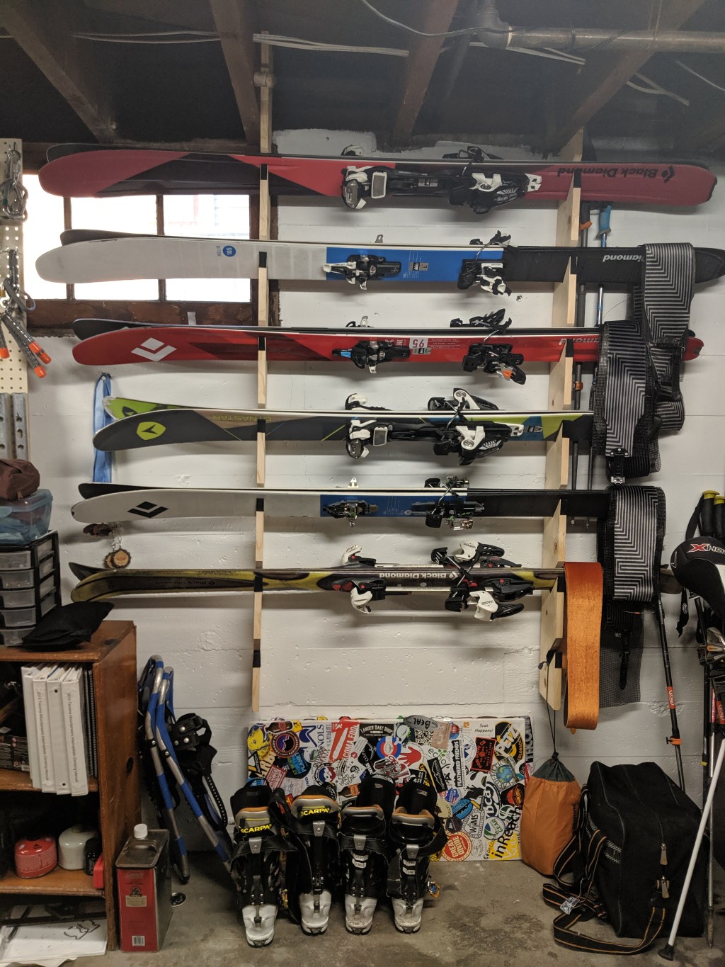 Wall-mounted rack for skis and snowboards.