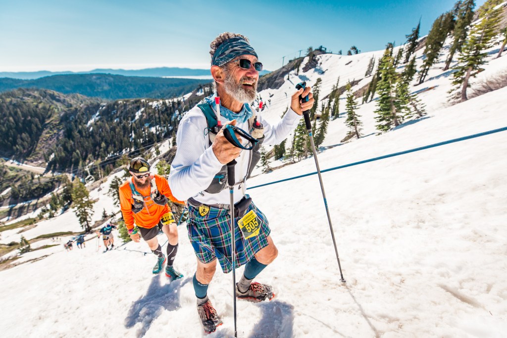 Runners climb up the slopes of Squaw Valley using trekking poles. 