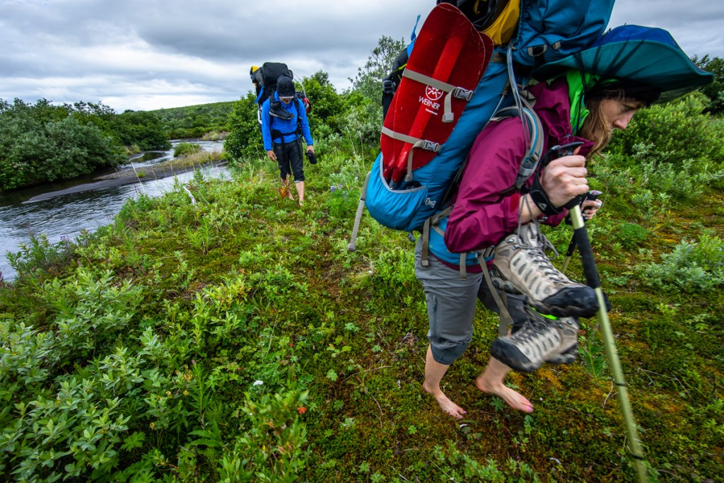 Shannon walking through greenery in Aniakchak