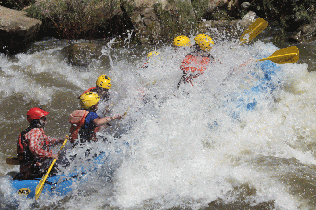 Rafters splash through whitewater