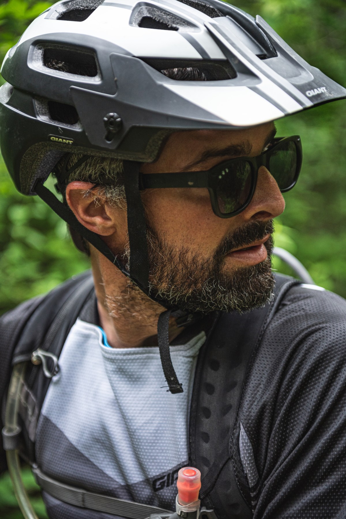 A portrait of JT Robinson wearing a bike helmet while riding trails in Wisconsin