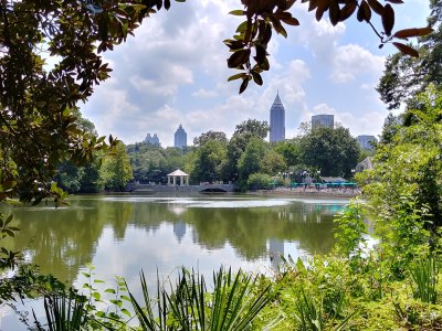 A view of midtown Atlanta skyline over a lake in Piedmont Park.