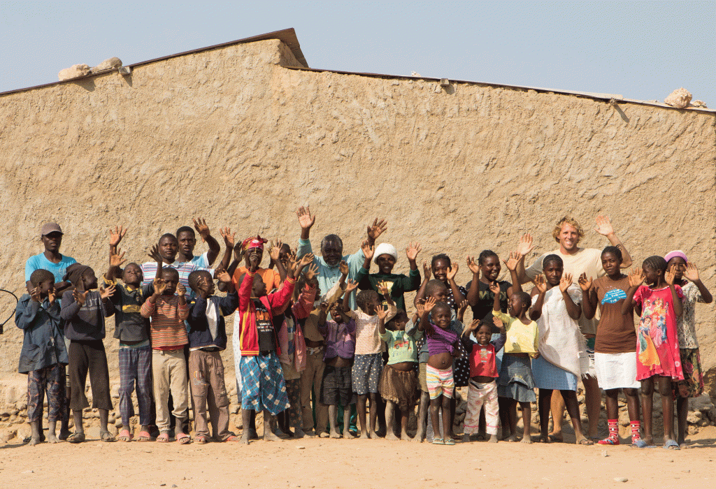 A smiling community poses for the camera in Africa