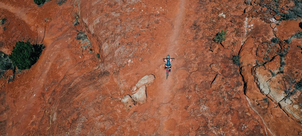 Cyclist going along red trail.