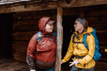 Two women have an in-depth conversation in the rain
