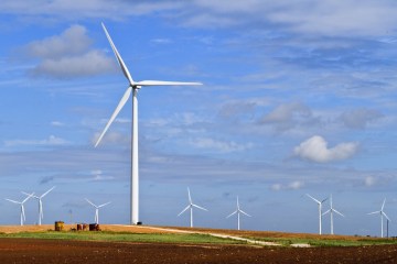 Blue skies, farm land, green crops, and rolling hills