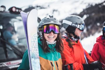 a smiling skier wearing goggles