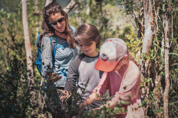 A mom and her kids spend time looking at nature