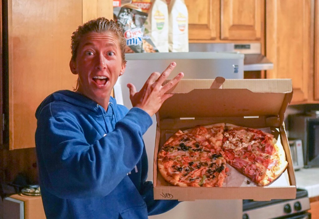 Courtney Dauwalter eats a pizza before a race.