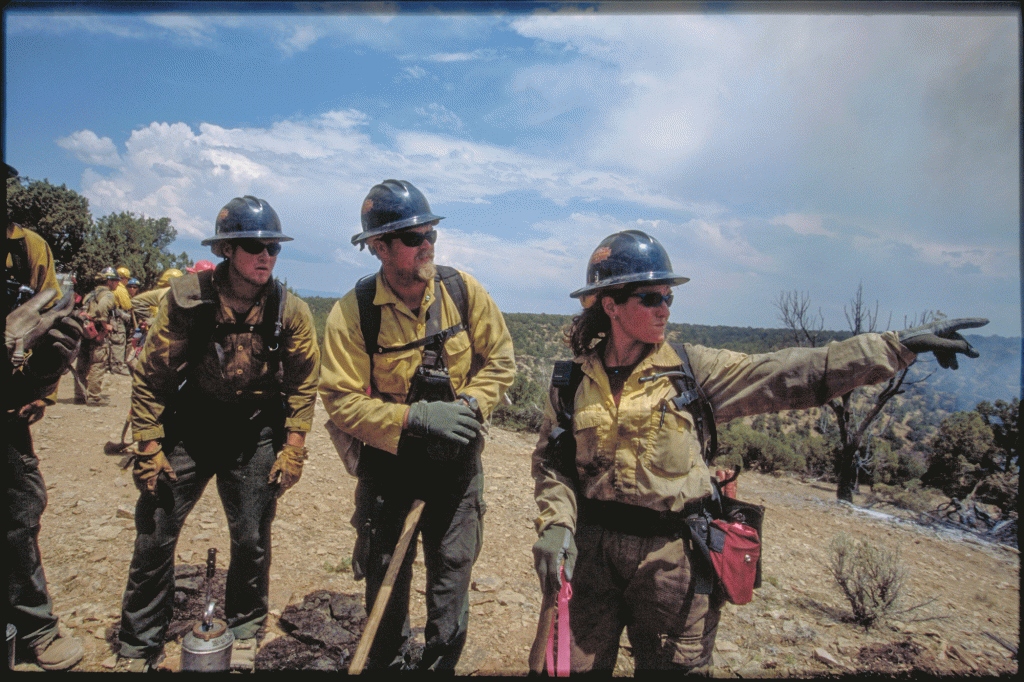 A firefighter points things out as she gives a safety officer briefing