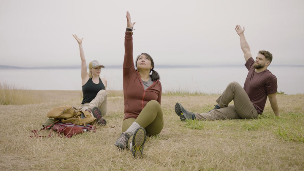 CorePower Yoga instructors hold a seated twist to stargazer pose