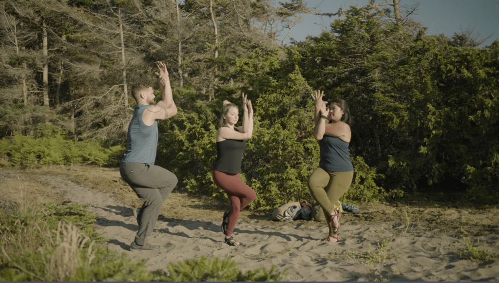 Corepower yoga instructors hold eagle pose