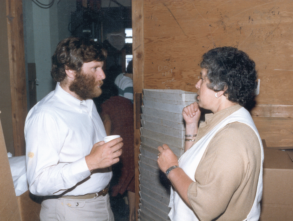 Tim and Gert Boyle stand sideways, having a conversation, in 1975