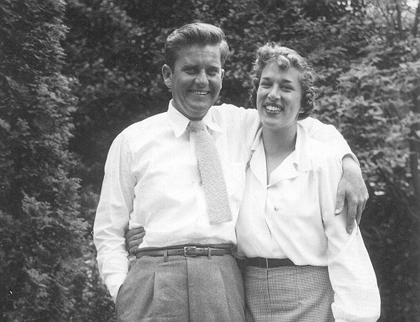 Gert and Neal Boyle stand in front of a forest as a young couple