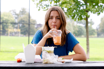 Erin Sullivan eating lunch, astounded by how much single-plastic is part of the meal