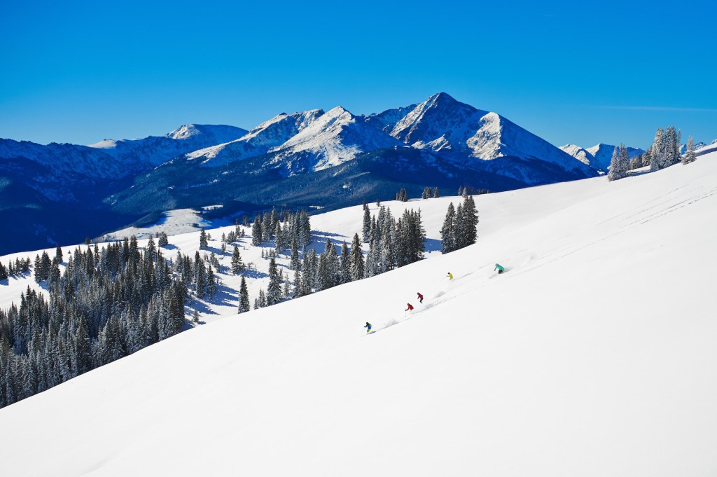 Skiers in the back bowl at Vail Mountain in Colorado.