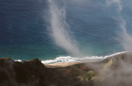 Fog rises above the ocean