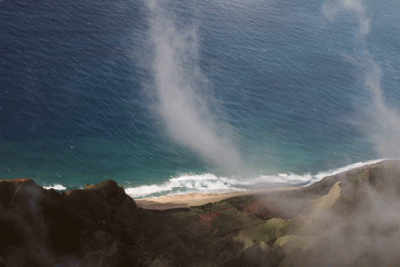 Fog rises above the ocean