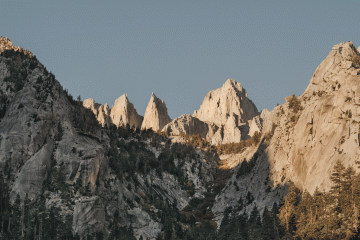 A mountain stands tall in the dying afternoon light