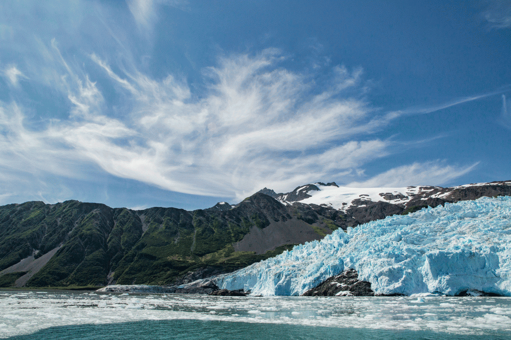 A glacier beneath a bright-blue sky