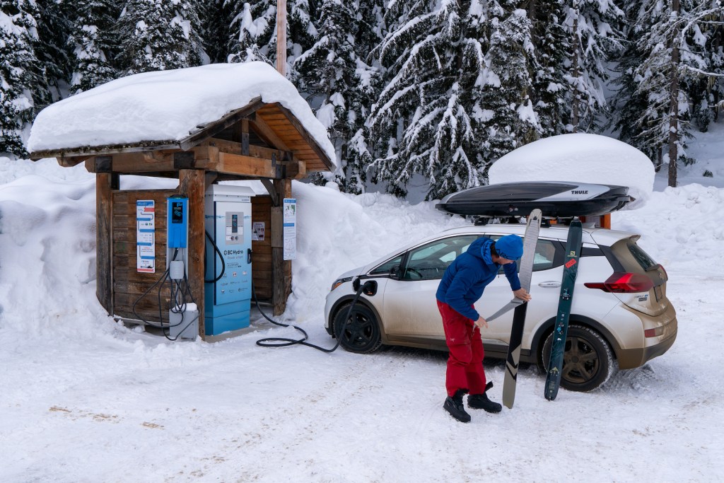 Ski mountaineer Greg Hill plugs in his electric car. 