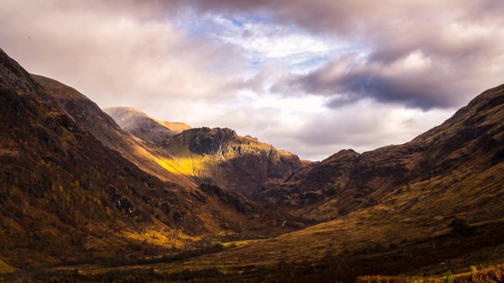 Clouds over a golden valley in the Scottish Highlands.