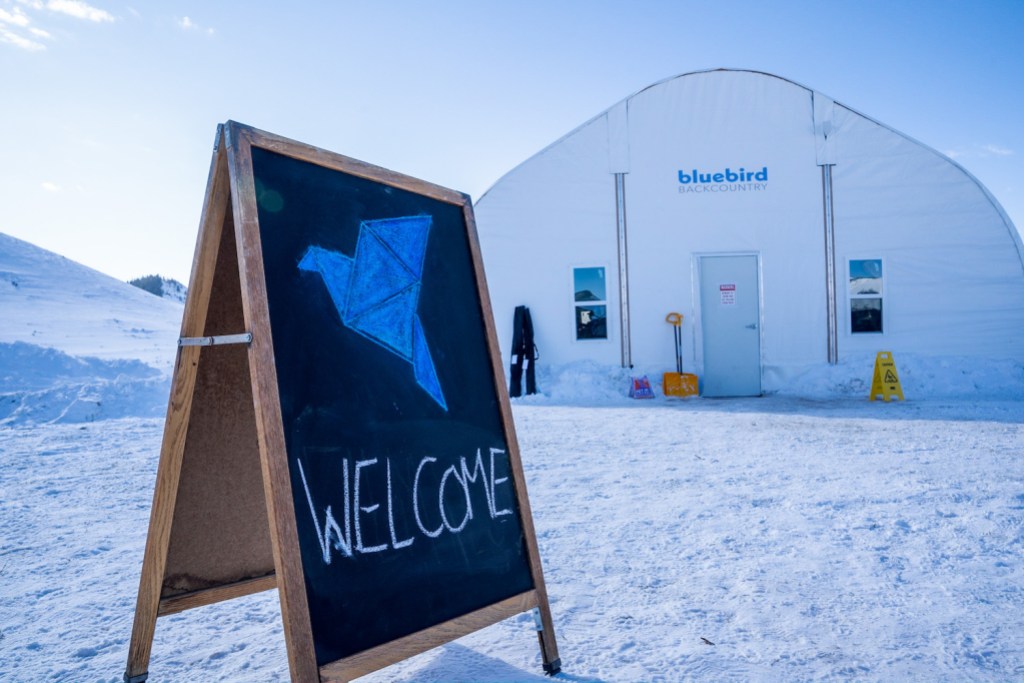 Warming hut and welcome sign at Bluebird Backcountry