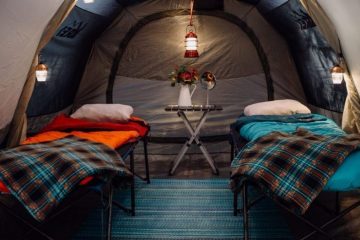 Tent with cots and sleeping bags inside